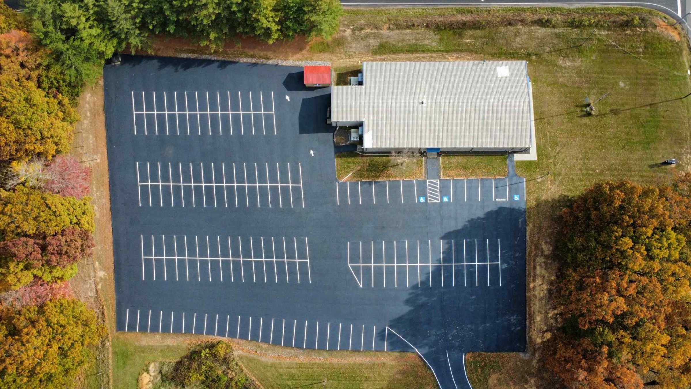 Aerial view of a parking lot freshly striped by LCS Striping